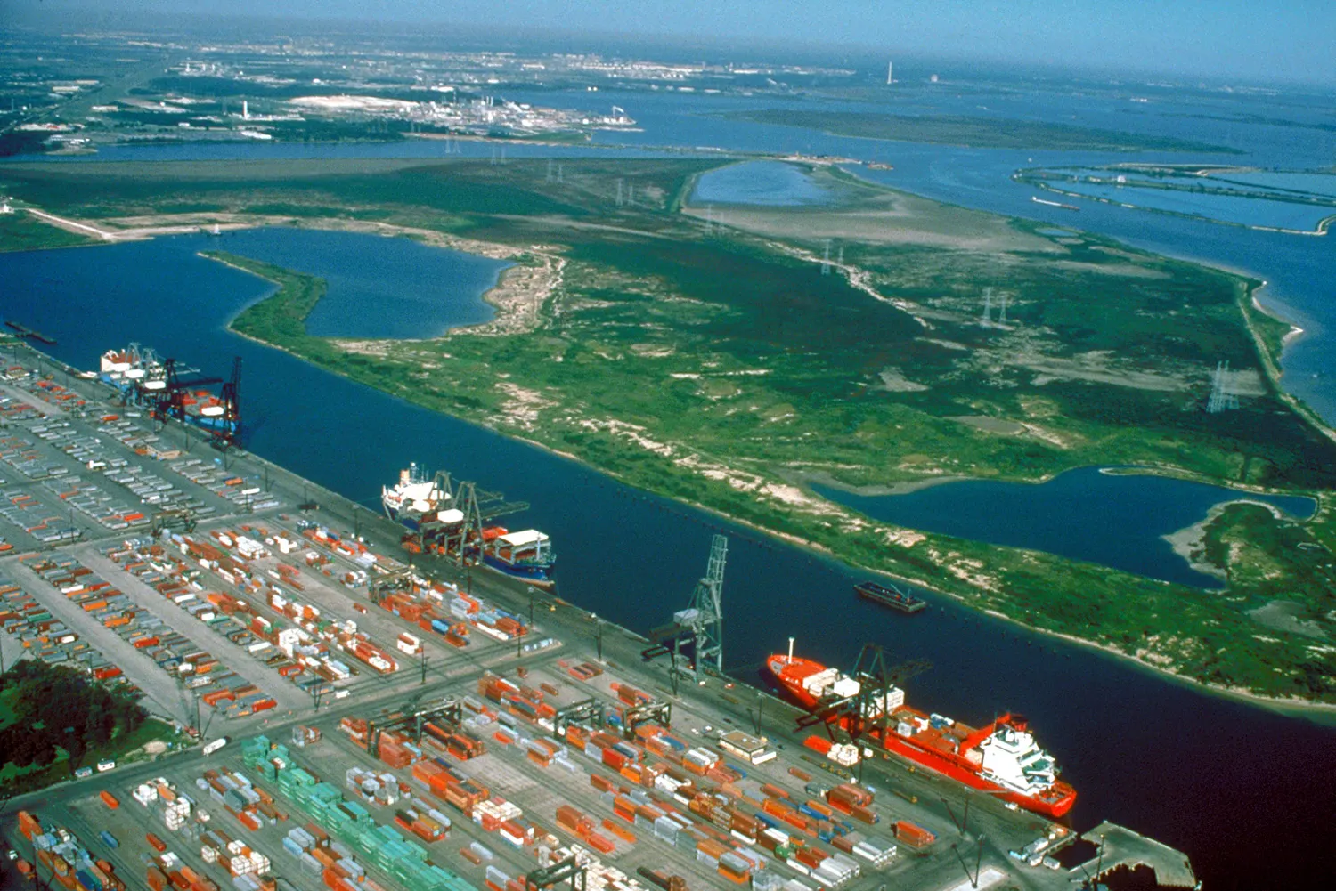 Aerial view of stacked containers, cranes and ships at a terminal on the Houston Ship Channel at Barbours Cut